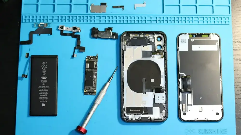 Разобранные детали iPhone на синем коврике